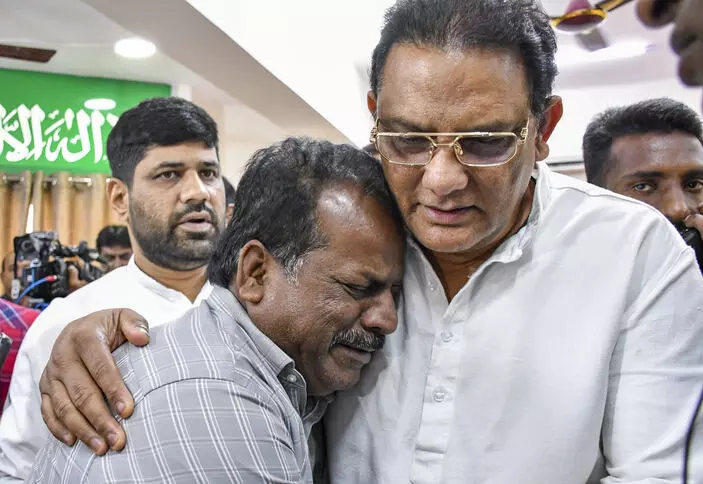 Telangana Minister Azharuddin consoling a relative of some of the victims