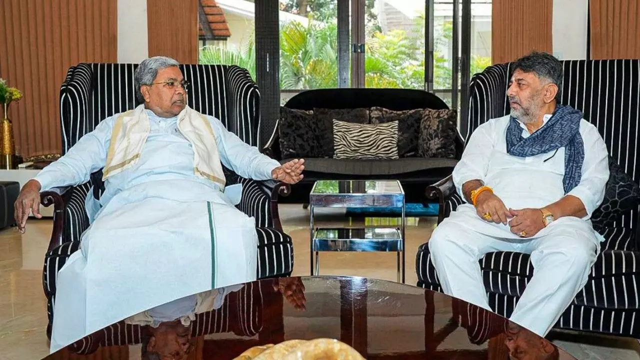 Karnataka Chief Minister Siddaramaiah interacts with Deputy CM DK Shivakumar during a breakfast meeting at his residence