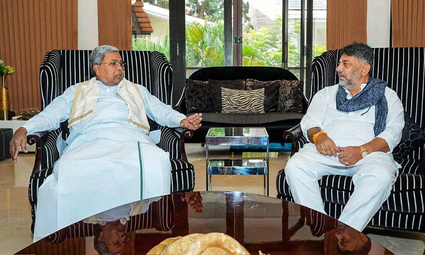 Karnataka Chief Minister Siddaramaiah interacts with Deputy CM DK Shivakumar during a breakfast meeting at his residence Karnataka Chief Minister Siddaramaiah interacts with Deputy CM DK Shivakumar during a breakfast meeting at his residence