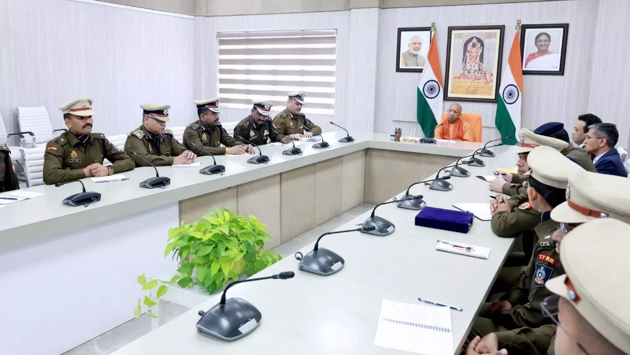 Uttar Pradesh Chief Minister Yogi Adityanath speaks with top police officers