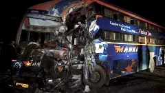 Damaged remains of a bus after it collided with a truck on the Jaipur Bikaner National Highway