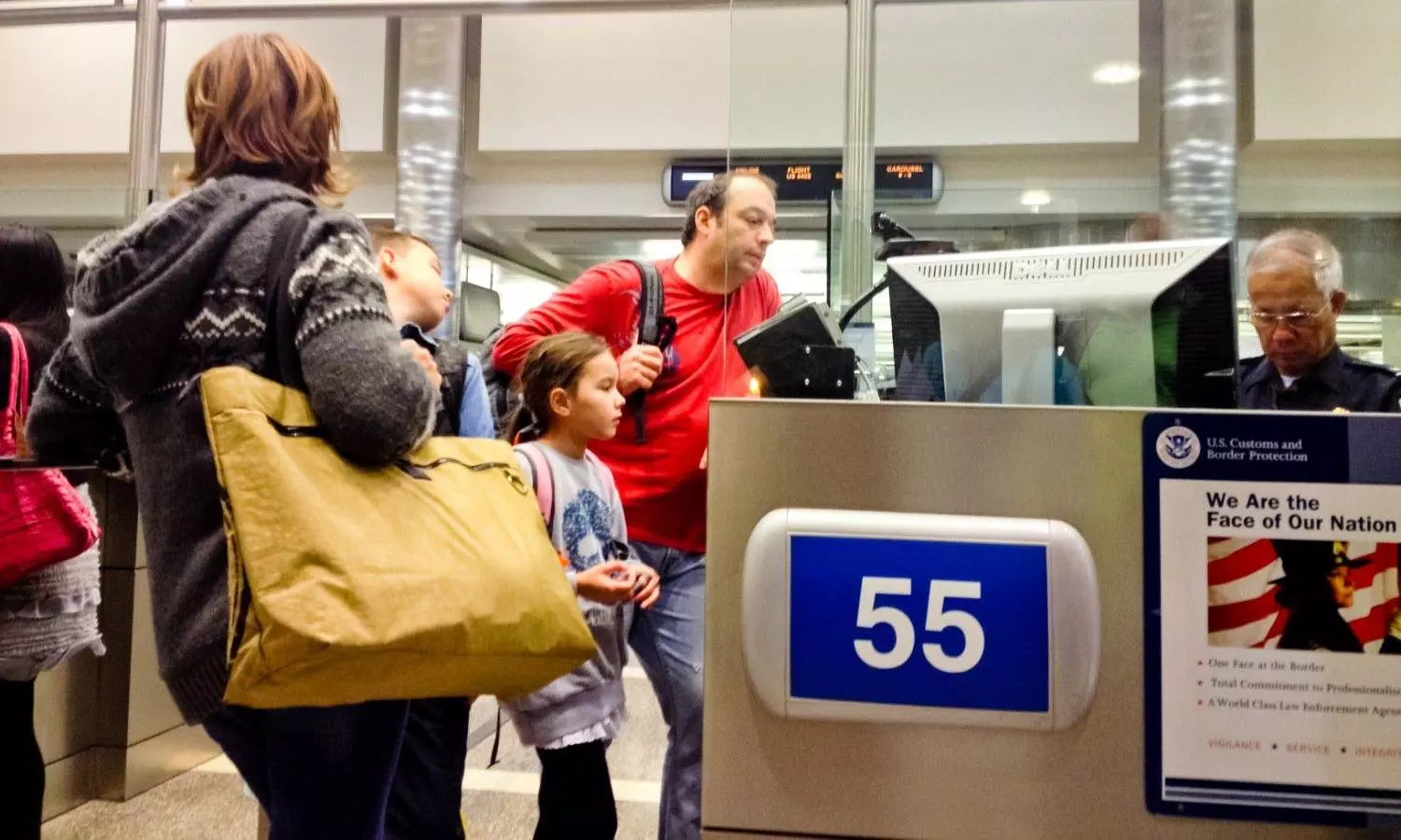 US Immigration officer checking documents of tourists stock photo US Immigration officer checking documents of tourists stock photo