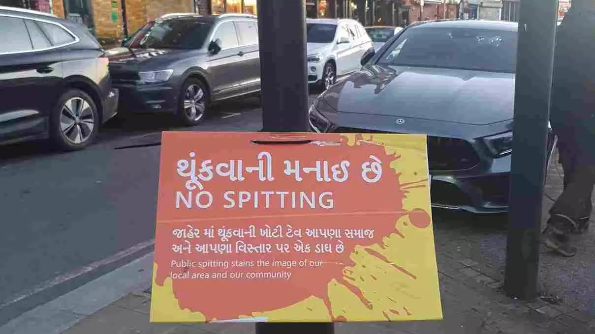 A No Spitting poster on a pole on the high street in Kingsbury, North West London – an area which has a large Gujarati population.