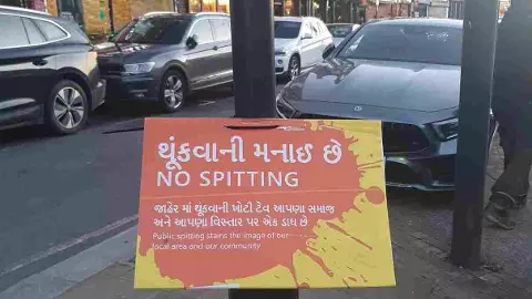 A No Spitting poster on a pole on the high street in Kingsbury, North West London – an area which has a large Gujarati population. A No Spitting poster on a pole on the high street in Kingsbury, North West London – an area which has a large Gujarati population.
