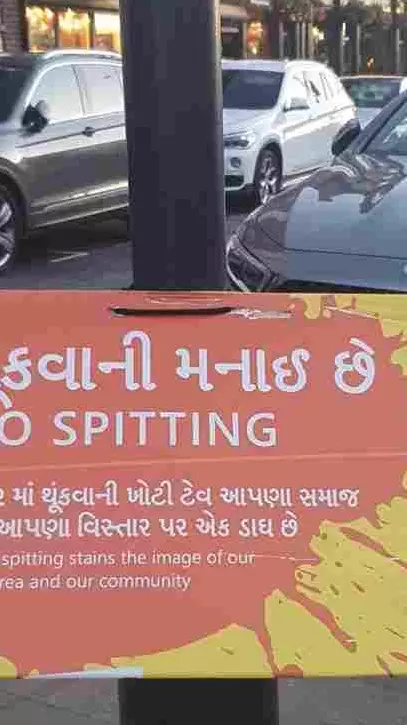A No Spitting poster on a pole on the high street in Kingsbury, North West London – an area which has a large Gujarati population.