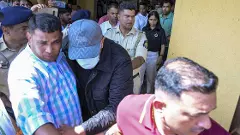 One of the Luthra brothers being escorted by police