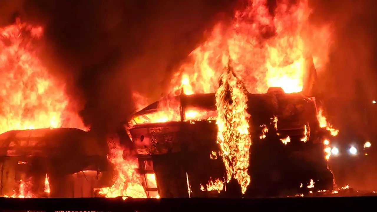 Flames and smoke billow out after a bus caught fire following a collision with a speeding truck