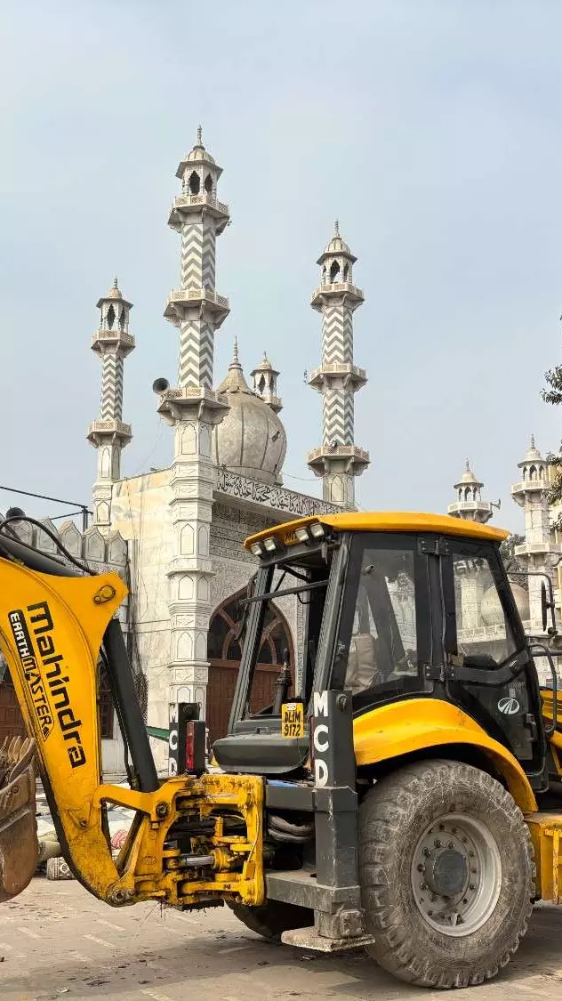 A bulldozer stands next to Faiz-e-Elahi Masjid in Old Delhi. A bulldozer stands next to Faiz-e-Elahi Masjid in Old Delhi.
