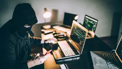 Computer hacker using phone stock photo