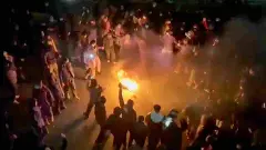 n this frame grab from footage circulating on social media shows protesters dancing and cheering around a bonfire as they take to the streets despite an intensifying crackdown as the Islamic Republic remains cut off from the rest of the world, in Tehran, Iran, Friday, Jan. 9, 2026.AP/PTI