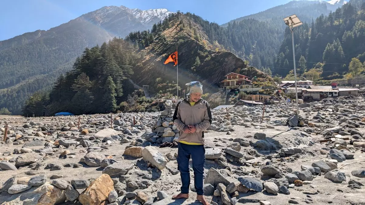 Amit Negi, one of the priests at Dharalis Kalp Kedar temple stands at the spot where the temple used to be before the flash floods. Photo: Manan Kumar