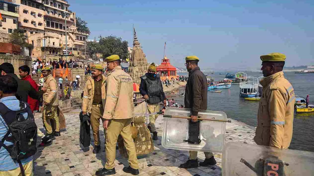 Police personnel stand guard at Manikarnika Ghat