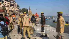 Police personnel stand guard at Manikarnika Ghat