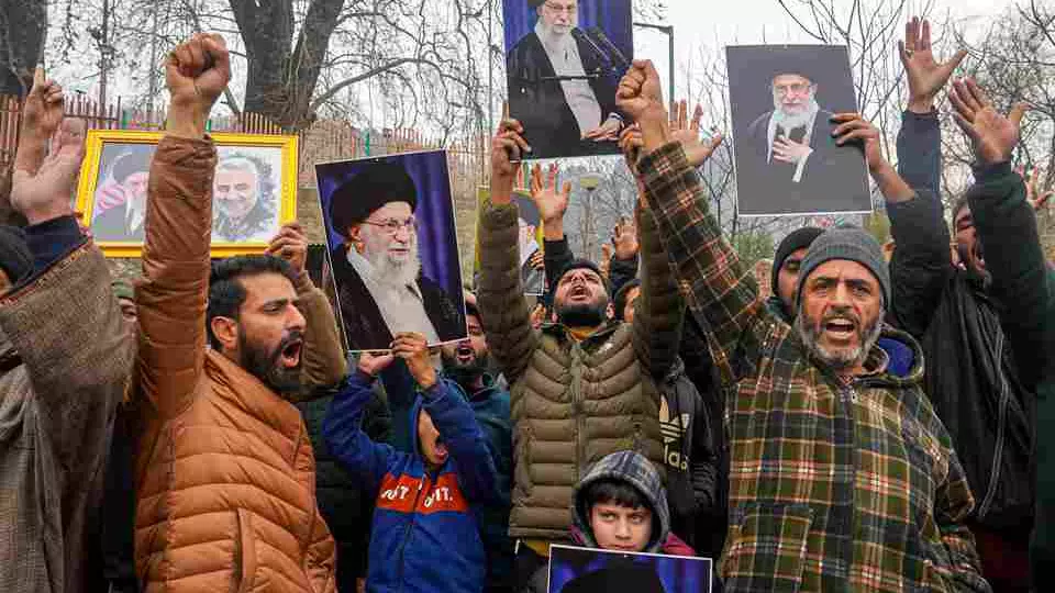 Agitators hold portraits of Iran