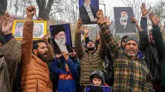 Agitators hold portraits of Iran