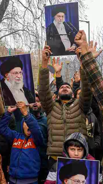 Agitators hold portraits of Iran
