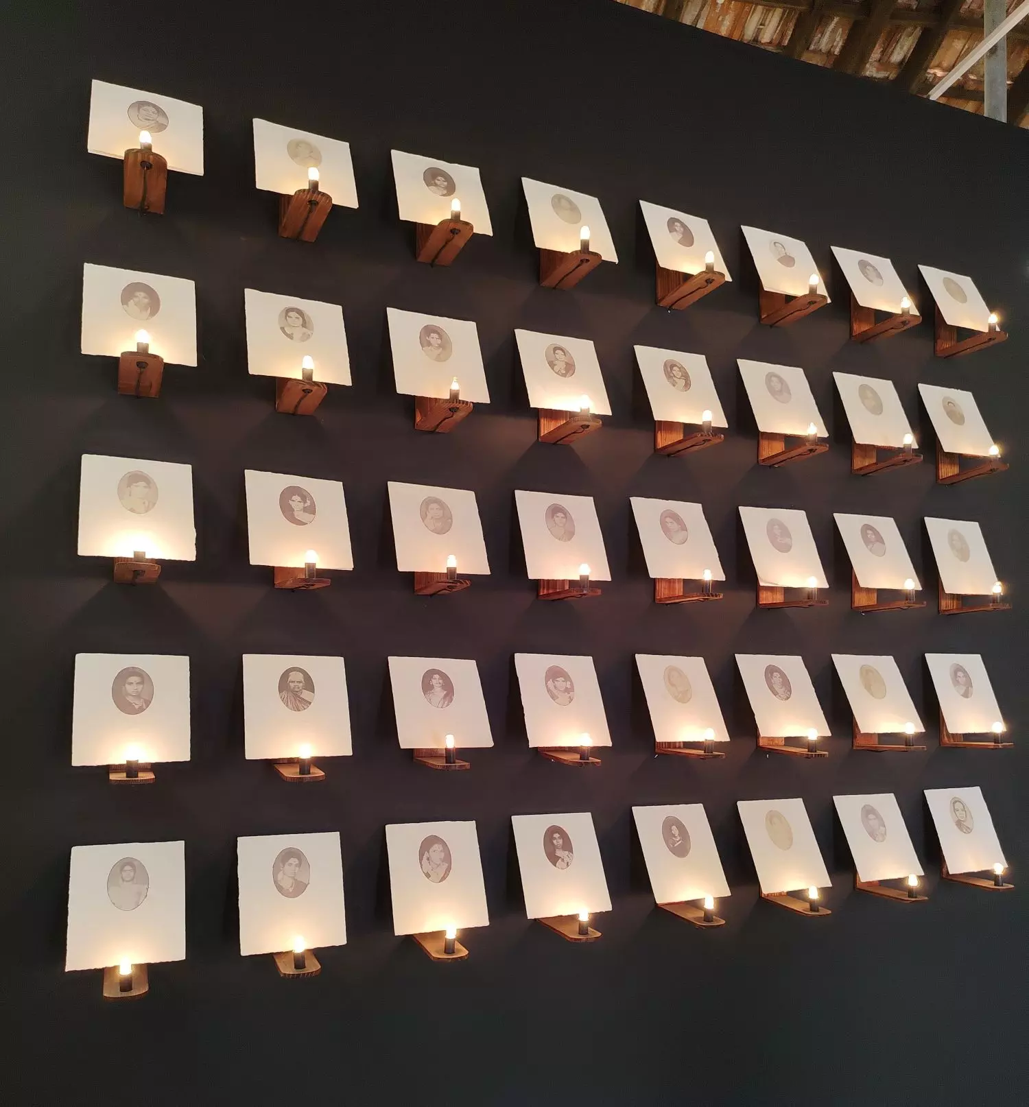 Evar (these people) is a collection of 40 photographs of women. Around each photo, Indu has stitched strands of her own hair. The photos are mounted like dots on a wall, with a lighted bulb at its tip. Photo: By special arrangement