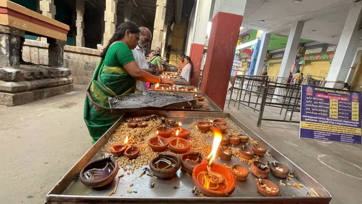 Women in silk sarees lit rows of clay lamps with soot-stained fingers, the performance of devotion more than a symbolic gesture. Photo: Veidehi Gite Women in silk sarees lit rows of clay lamps with soot-stained fingers, the performance of devotion more than a symbolic gesture. Photo: Veidehi Gite