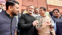 Leader of Opposition in the Lok Sabha Rahul Gandhi shows a copy of the unpublished memoir of former Army chief M M Naravane