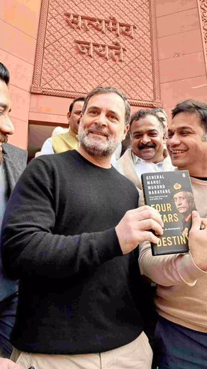 Leader of Opposition in the Lok Sabha Rahul Gandhi shows a copy of the unpublished memoir of former Army chief M M Naravane