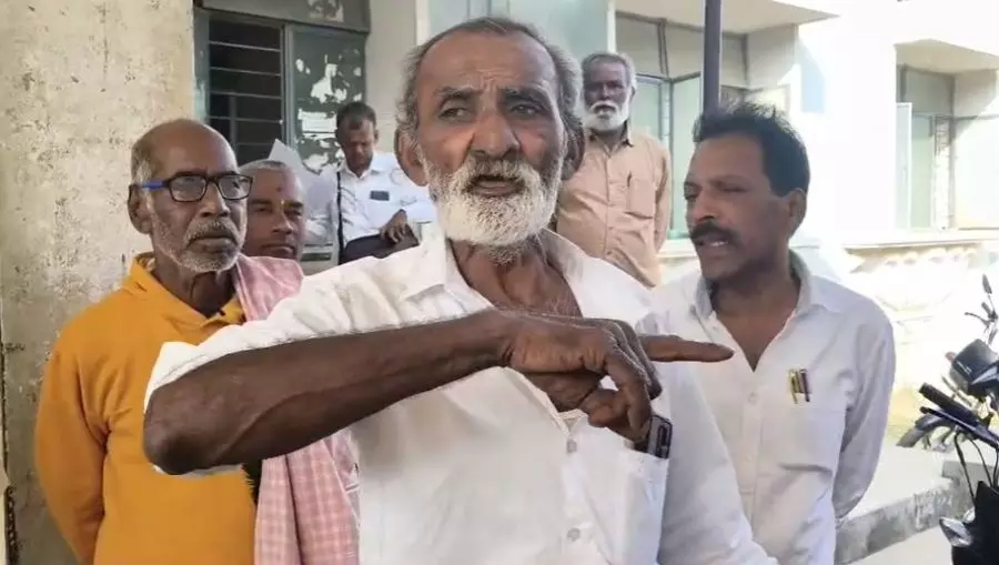Prasanna Kumar protests outside teh tahsildars office. Photo: By special arrangement