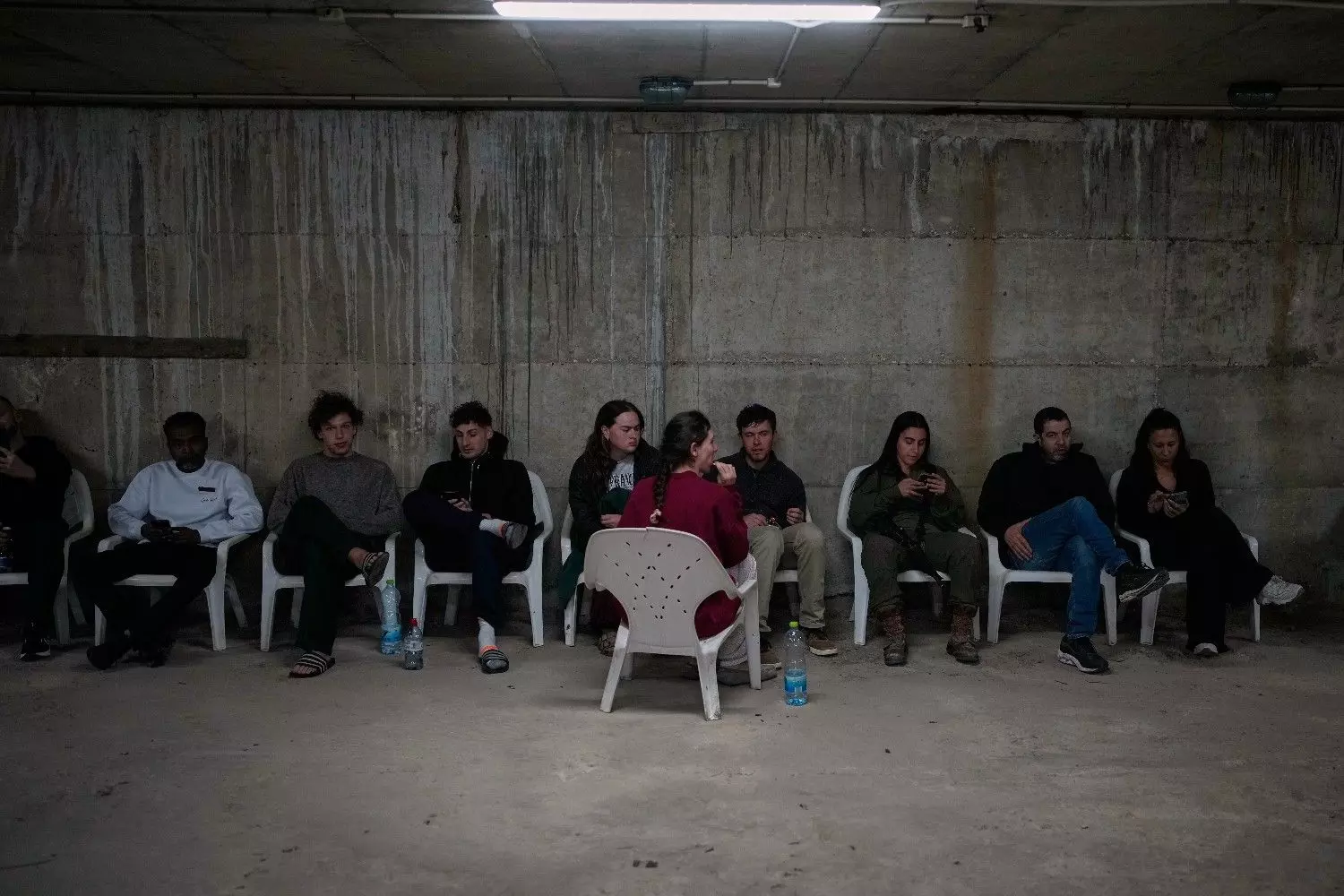 People sit in a shelter after warning sirens sound following Israeli strikes on Iran, in Tel Aviv, Israel, Saturday, February 28. AP/PTI People sit in a shelter after warning sirens sound following Israeli strikes on Iran, in Tel Aviv, Israel, Saturday, February 28. AP/PTI