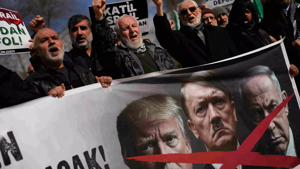 People chant slogans as they protest against US and Israeli strikes