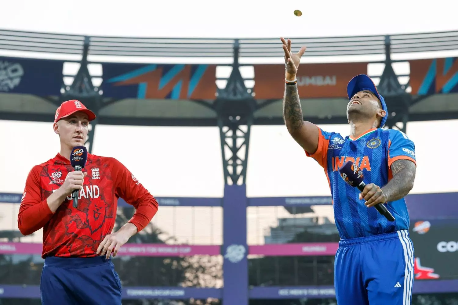India captain Suryakumar Yadav (right) tosses the coin as his England counterpart calls. Photo: BCCI