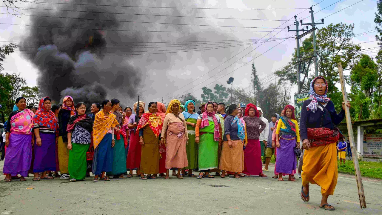 People block a road in protest after two children were killed in bomb attack Bishnupur district