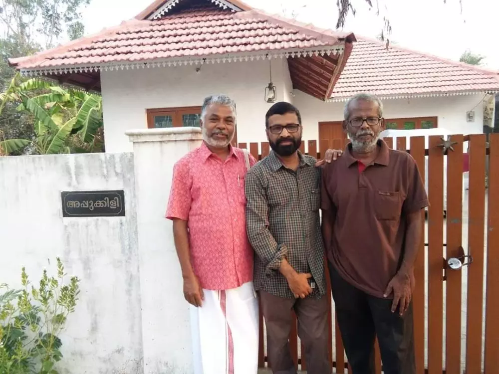 PV Sukumaran (centre) with writer Perumal Murugan (left) & Yuma Vasuki, who had won the Sahitya Akademi award for his Tamil translation of Khasakkinte Ithihasam, outside the house in Thasarak named after Appu-Kili. Photo: By special arrangement