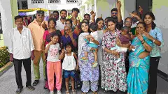 Members of a three-generation family show their inked fingers after voting