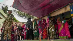 People wait in a queue in Nandigram, West Bengal