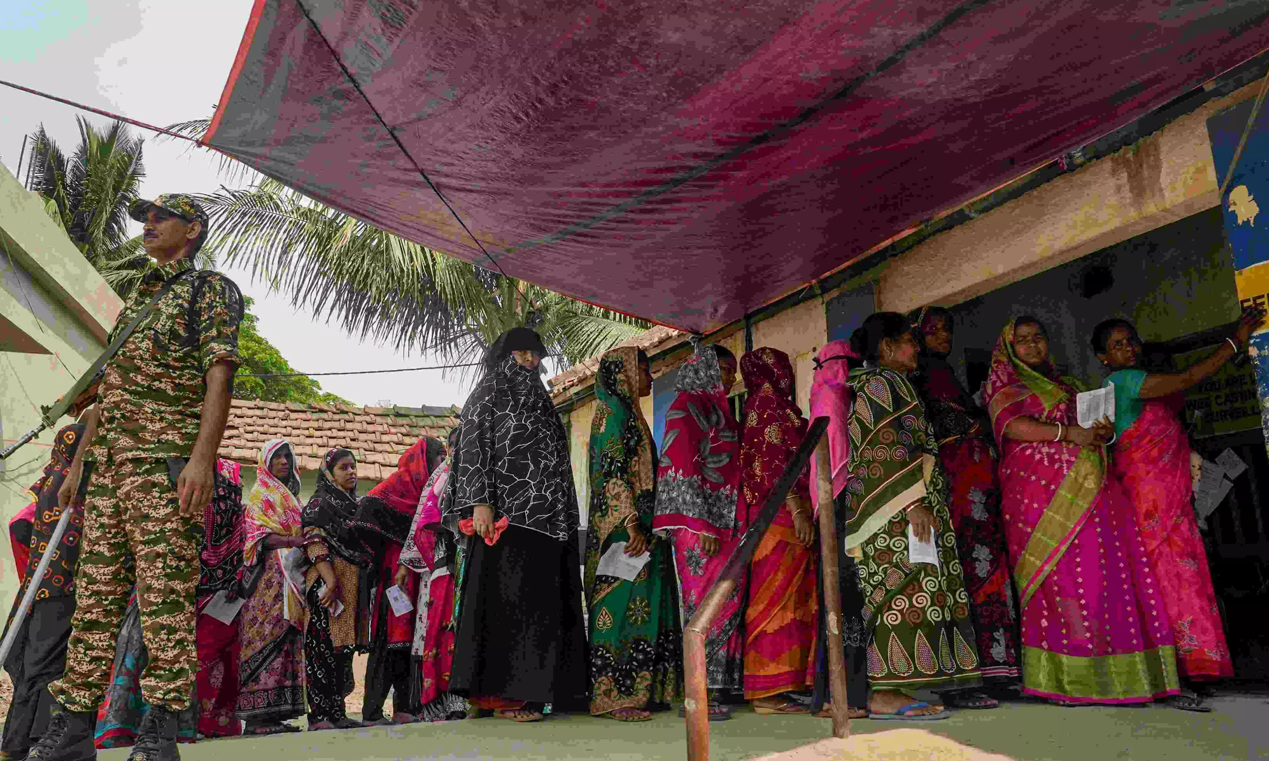 People wait in a queue in Nandigram, West Bengal People wait in a queue in Nandigram, West Bengal