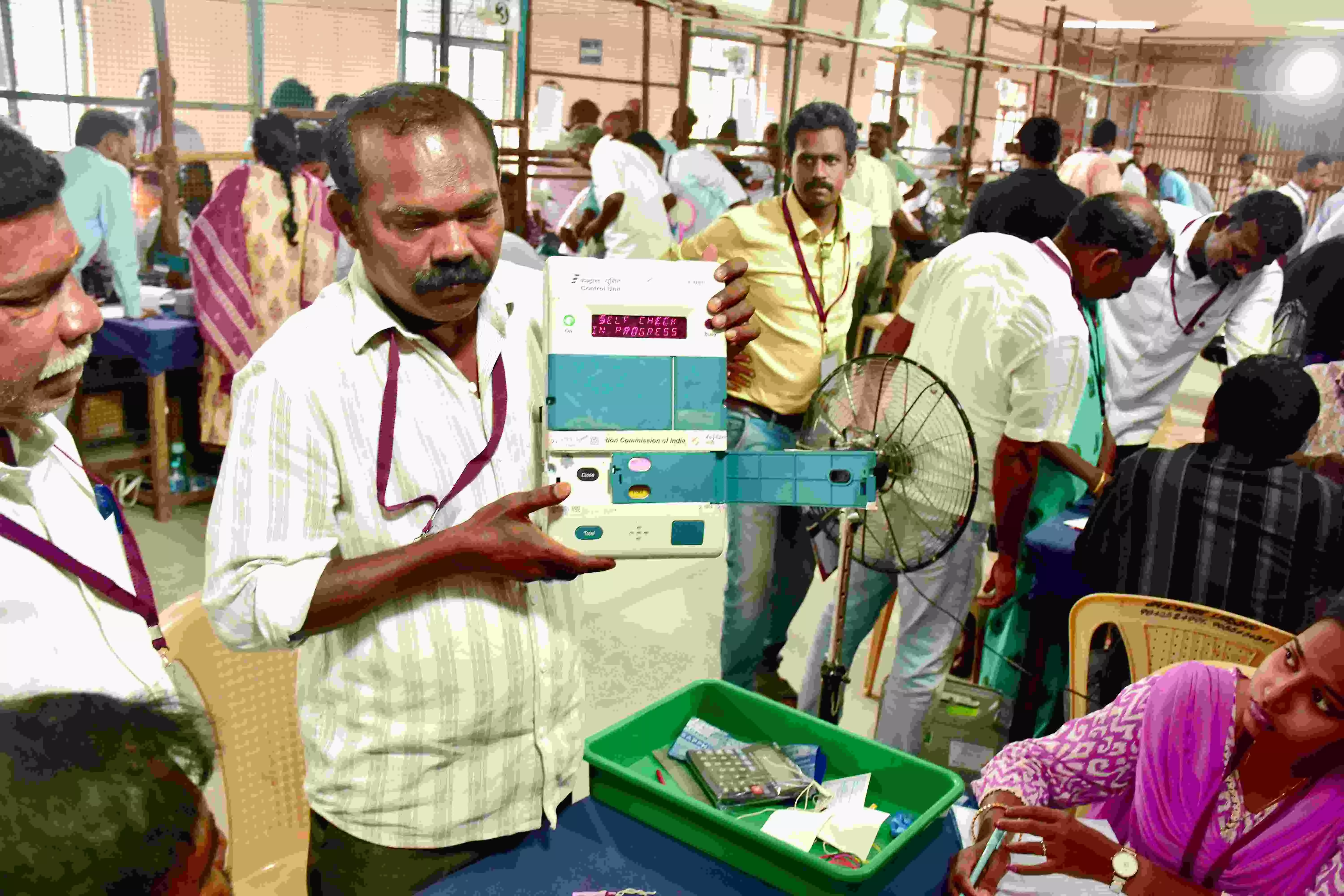 An election official demonstrates an electronic voting machine (EVM) during vote counting at a counting centre, in Madurai An election official demonstrates an electronic voting machine (EVM) during vote counting at a counting centre, in Madurai