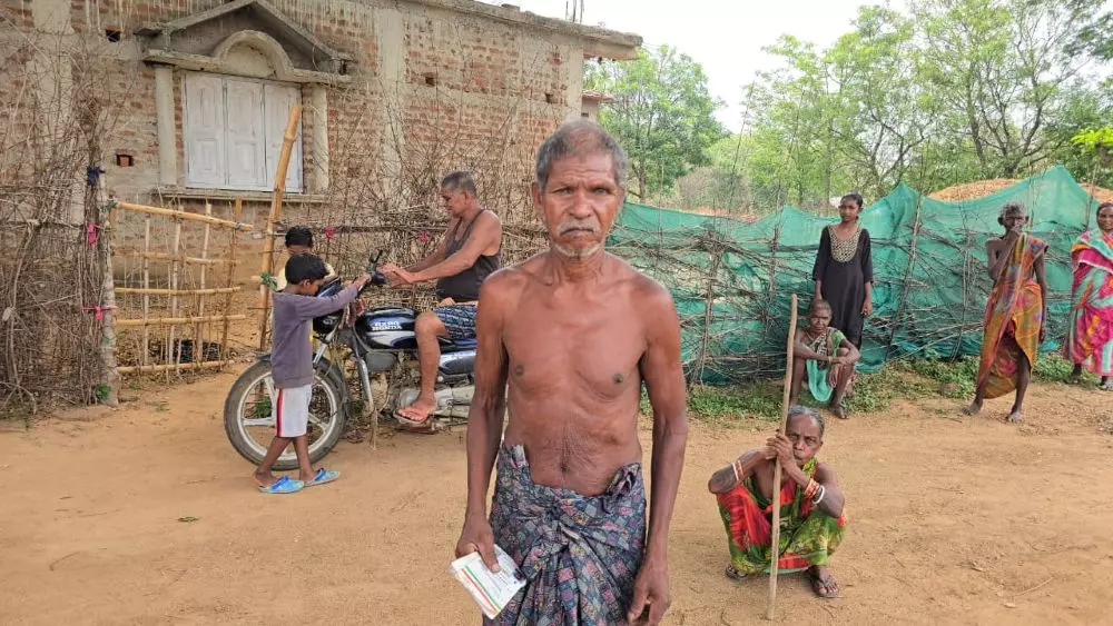 Jitu Munda holds his new Aadhaar card in hand. Photo: By special arrangement