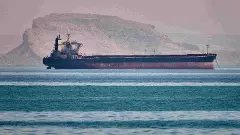 A bulk cargo ship sits at anchor in the Strait of Hormuz off Bandar Abbas, Iran
