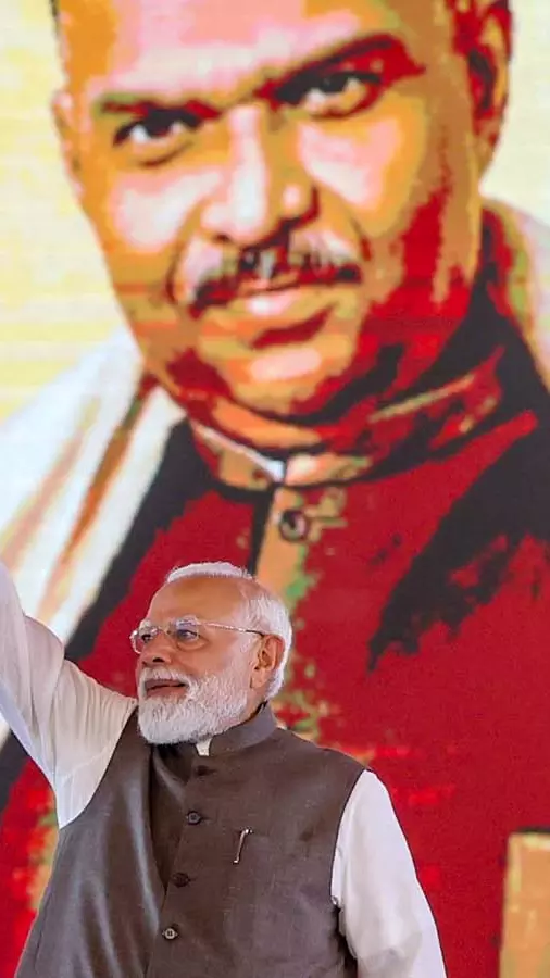 PM Narendra Modi in front of an image of Syama Prasad Mookerjee