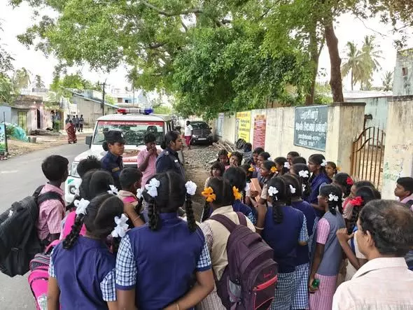 Singappen officers with school children at an event to build public awareness. Photo: By special arrangement