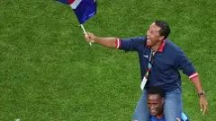 Cape Verde football coach Bubista waving nations flag