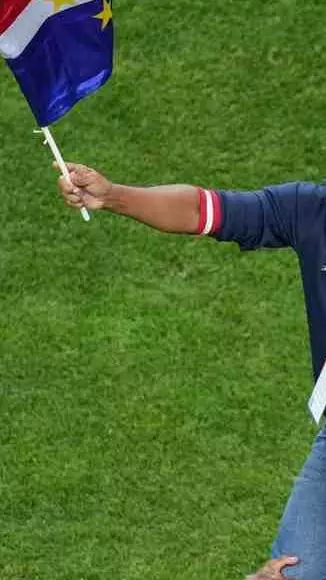 Cape Verde football coach Bubista waving nations flag