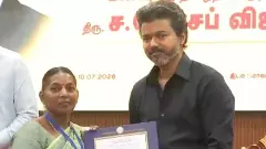 Tamil Nadu CM Joseph Vijay handing over job order to a beneficiary Tamil Nadu CM Joseph Vijay handing over job order to a beneficiary