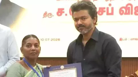 Tamil Nadu CM Joseph Vijay handing over job order to a beneficiary
