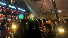 people watching football match in a pub