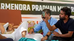 Cockroach Janata Party (CJP) founder Abhijeet Dipke, right, looks on as a medical professional attends climate activist Sonam Wangchuk
