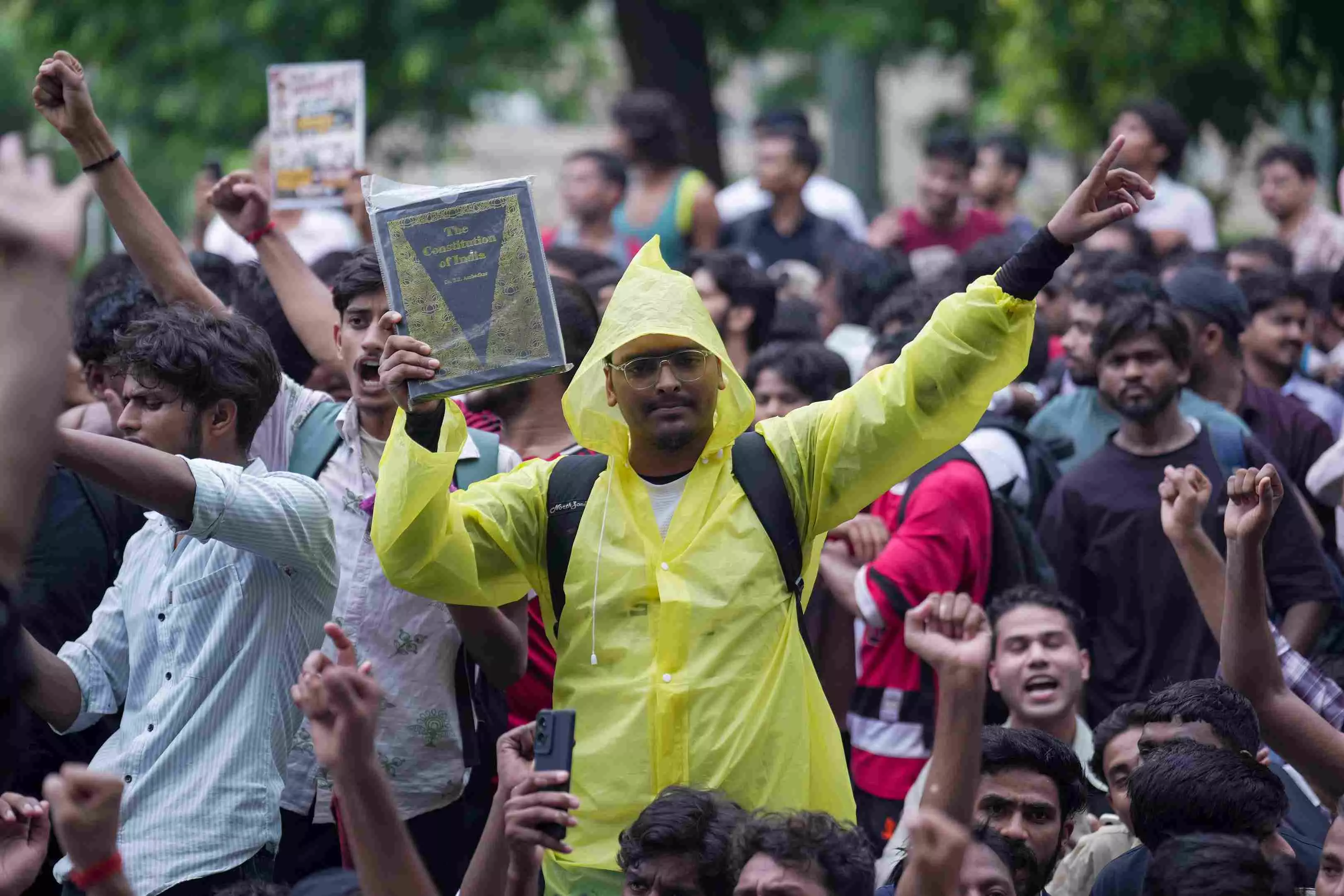 A protestor holds up a copy of the Constitution of India. File photo A protestor holds up a copy of the Constitution of India. File photo