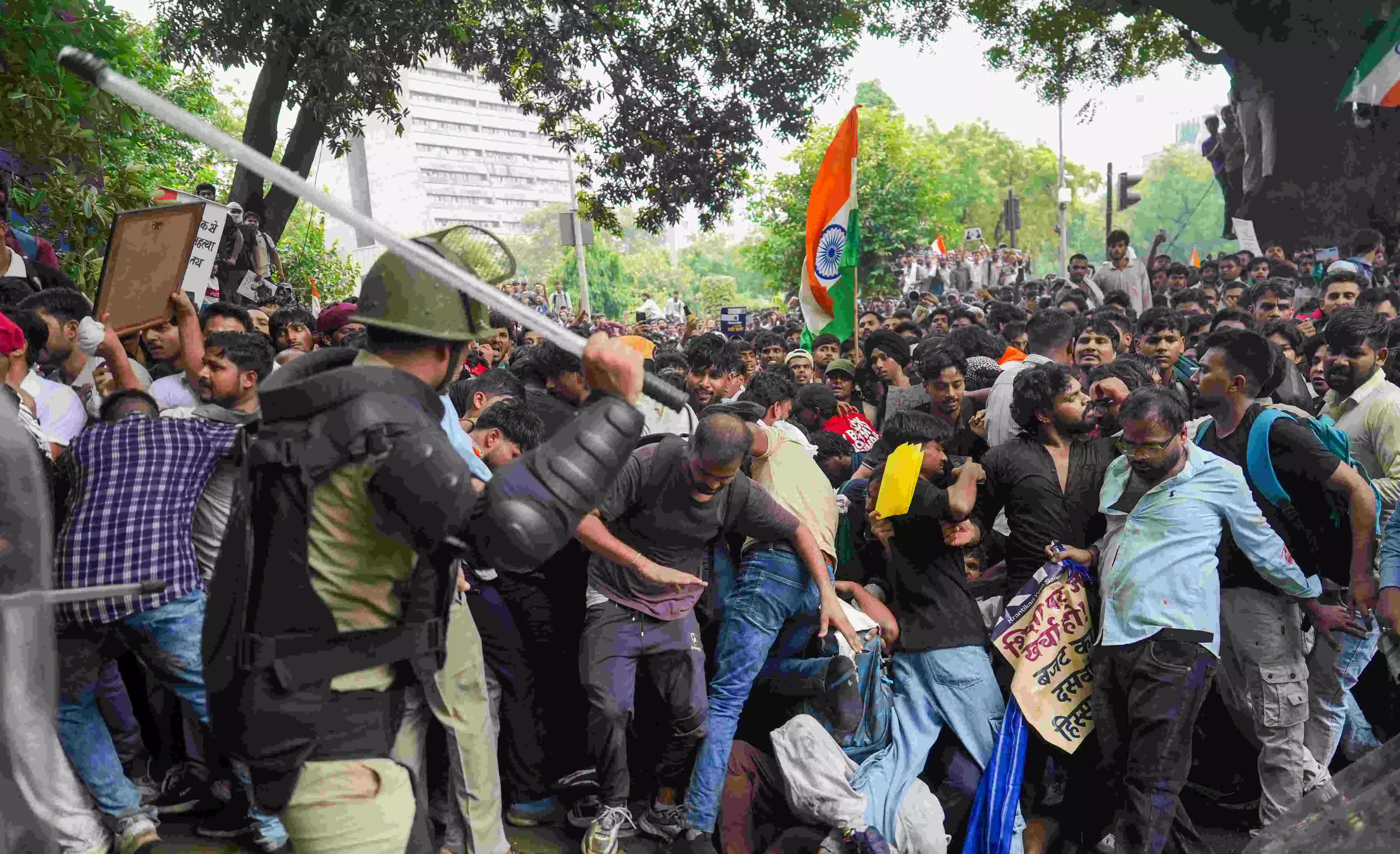 Security personnel stop Cockroach Janata Party (CJP) supporters as they raise slogans near Jantar Mantar during a protest march, in New Delhi. PHOTO: PTI
