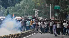 Protesters gather amid tear gas smoke during the demonstration