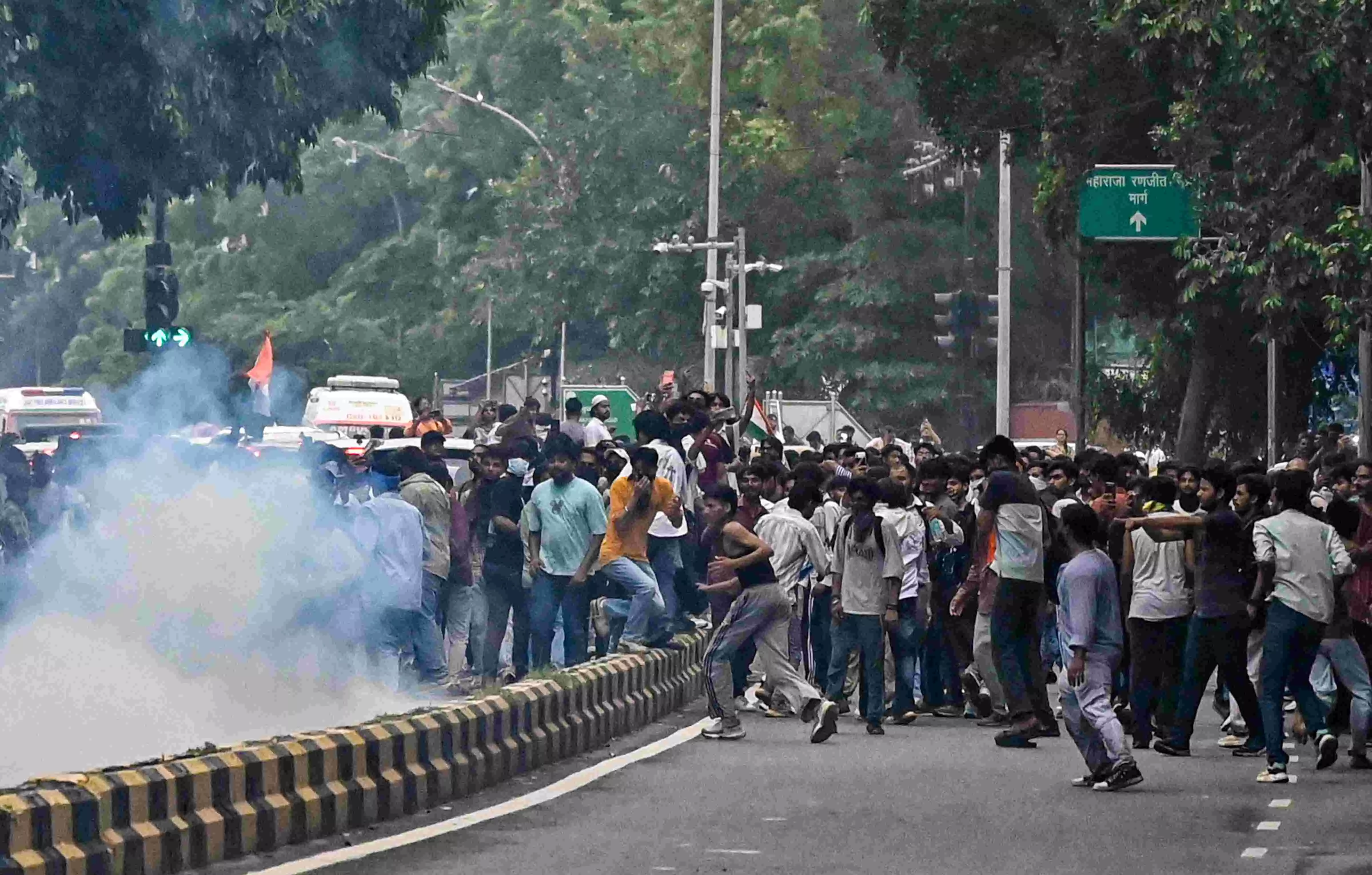 Protesters gather amid tear gas smoke during the demonstration Protesters gather amid tear gas smoke during the demonstration