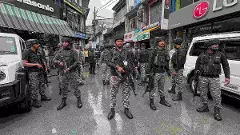 Security personnel conduct a search operation following a terrorist attack in which a police head constable was killed, in Anantnag