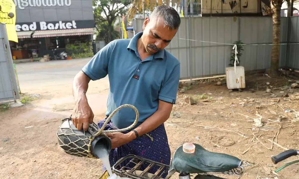 Tappers work in three shifts through the day, collecting and delivering the sap for sale. Photo: Ima Babu